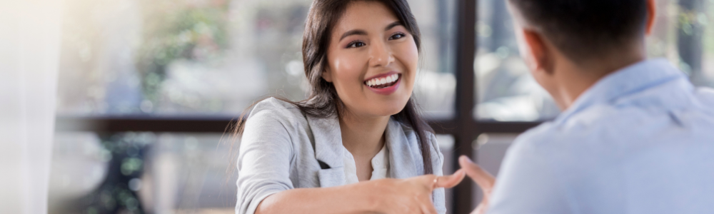young woman shaking hand of man