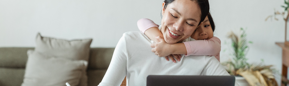 woman with child working on laptop