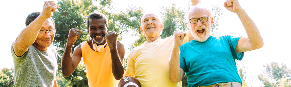 group of diverse senior men posing together, laughing, outdors with football