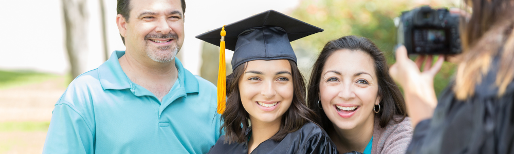 parents posing for photo with daughter in cap and gown
